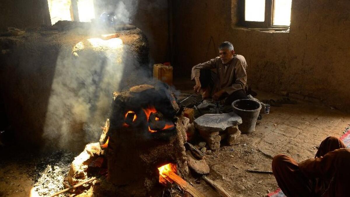 An Afghan man works at a factory which produces traditional glassware handicrafts in Herat (AFP)