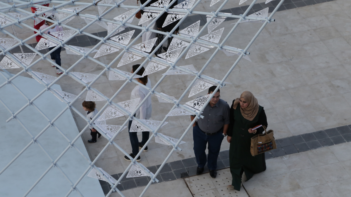 Attendees at Amman Design Week walk under a swarm of mechanical butterflies in a project called ‘A Path of Synergy,’ created by architects and visual artists Rawan Kakish and Hamad al Sultan. (Al Bawaba/Salim Essaid)