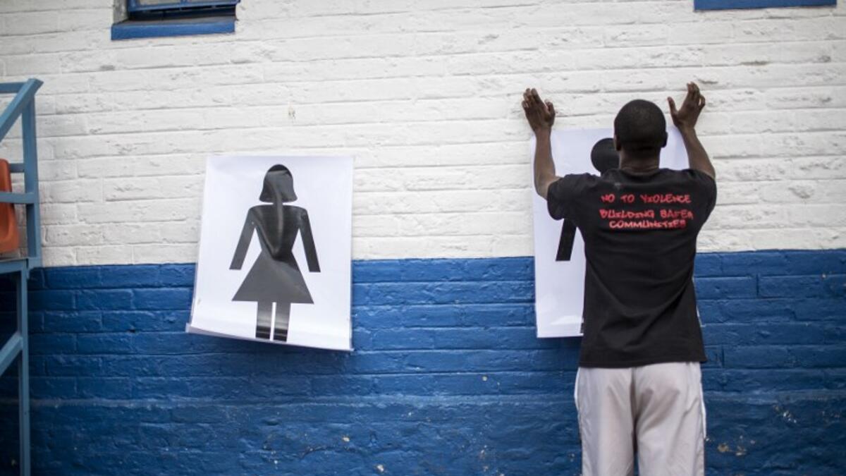 Instructor Den Manda (23) puts up charts on a wall during a session with NGO Action Breaks Silence (ABS). (GULSHAN KHAN / AFP)