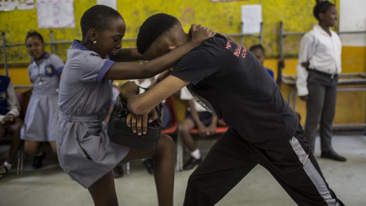 Girls practice self defence methods during a session with NGO Action Breaks Silence (ABS) called "Empowerment through self-defence for women and girls". (GULSHAN KHAN / AFP)
