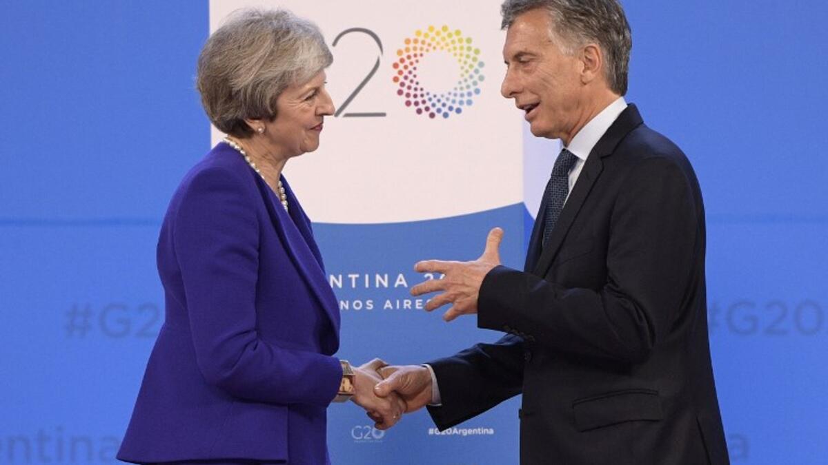 Britain's Prime Minister Theresa May (L) is welcomed by Argentina's President Mauricio Macri at Costa Salguero in Buenos Aires during the G20 Leaders' Summit, on November 30, 2018.
Juan Mabromata / AFP