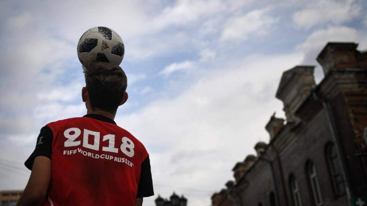 A man juggles a football in the street in Ekaterinburg on June 16, 2018, during the Russia 2018 World Cup football tournament. 
Anne-Christine POUJOULAT / AFP