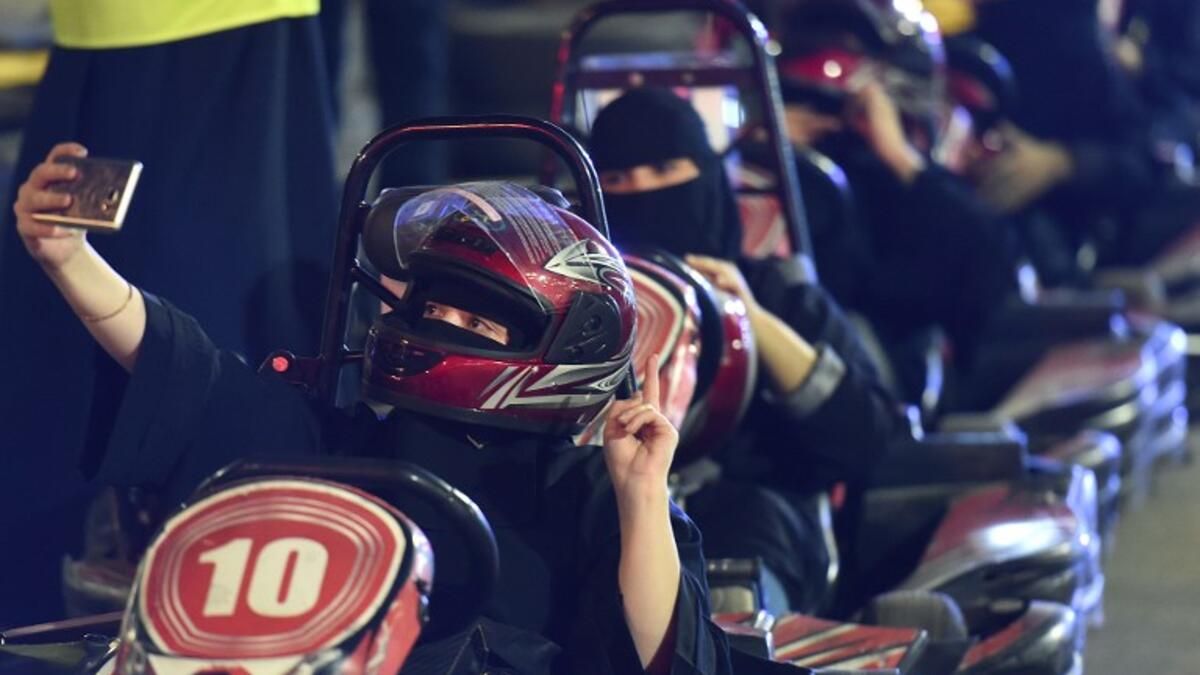 A Saudi woman takes selfi as she uses a go-cart during a driving workshop for women in the Saudi capital Riyadh on June 21, 2018. 
FAYEZ NURELDINE / AFP