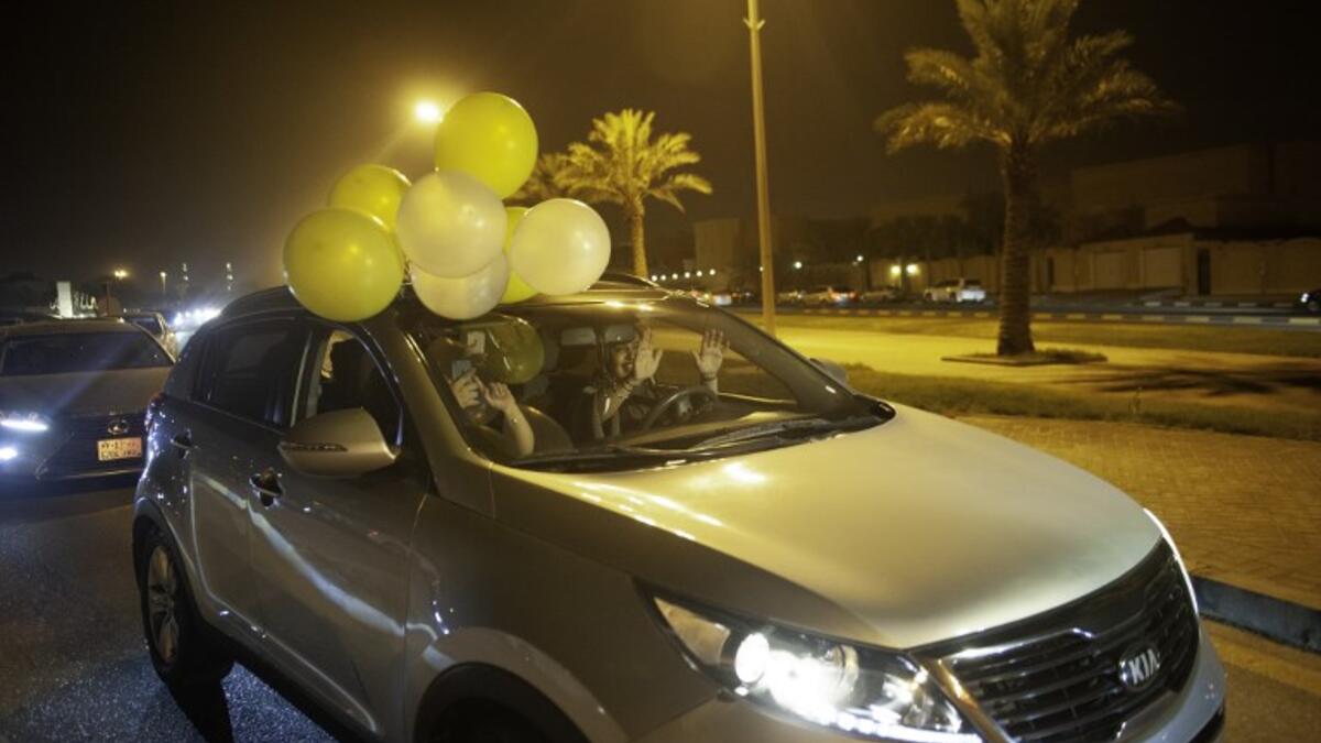 A Saudi woman and her friends celebrate her first time driving on a main street of Khobar City on her way to Kingdom of Bahrain on June 24, 2018.
HUSSAIN RADWAN / AFP