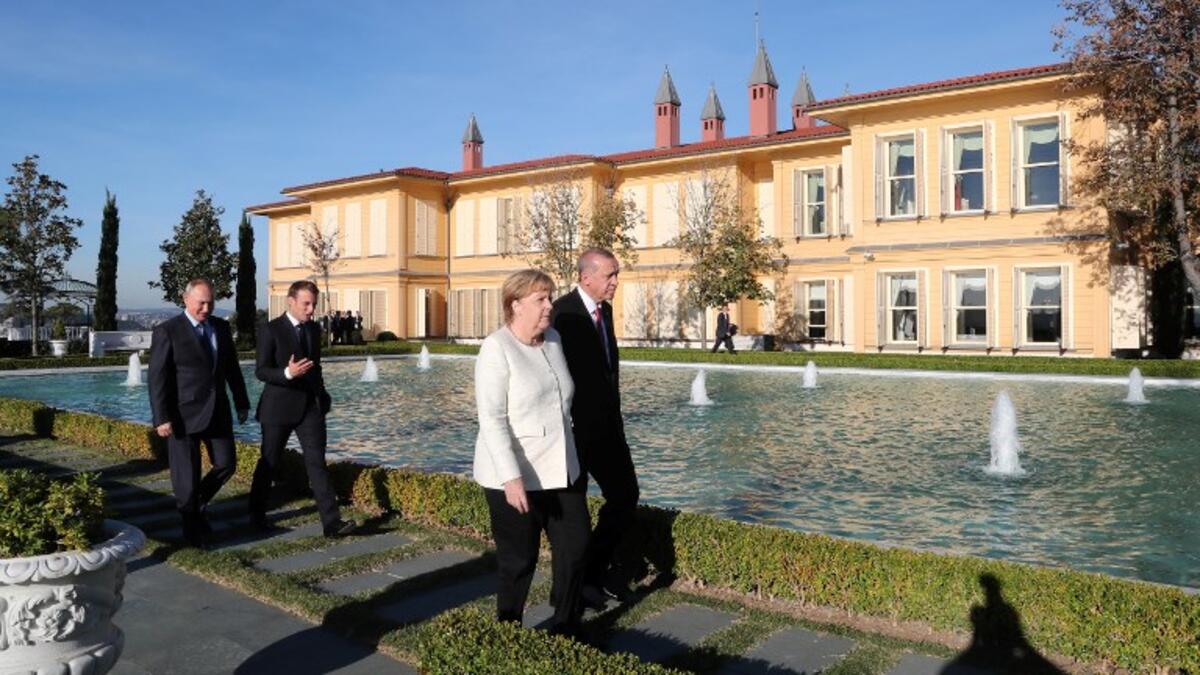 (From L) Russian President Vladimir Putin, French President Emmanuel Macron, German Chancellor Angela Merkel, and Turkish President Recep Tayyip Erdogan walk in the garden of the Vahdettin Mansion in Istanbul, on October 27, 2018. (Kayhan OZER / POOL / AFP)