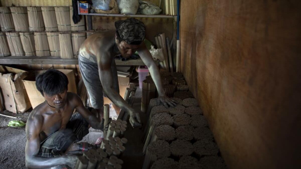 Workers covered with gunpowder material make fireworks for New Year celebrations in Bocaue, Bulacan, north of Manila on December 26, 2018. 
Noel CELIS / AFP