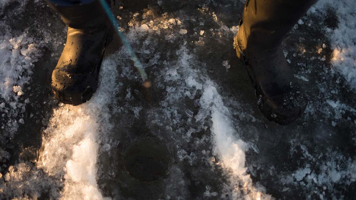 A man is ice-fishing at midday on the frozen Bothnia Sea, on December 28, 2016 in Vaasa, Western Finland. (OLIVIER MORIN/AFP)