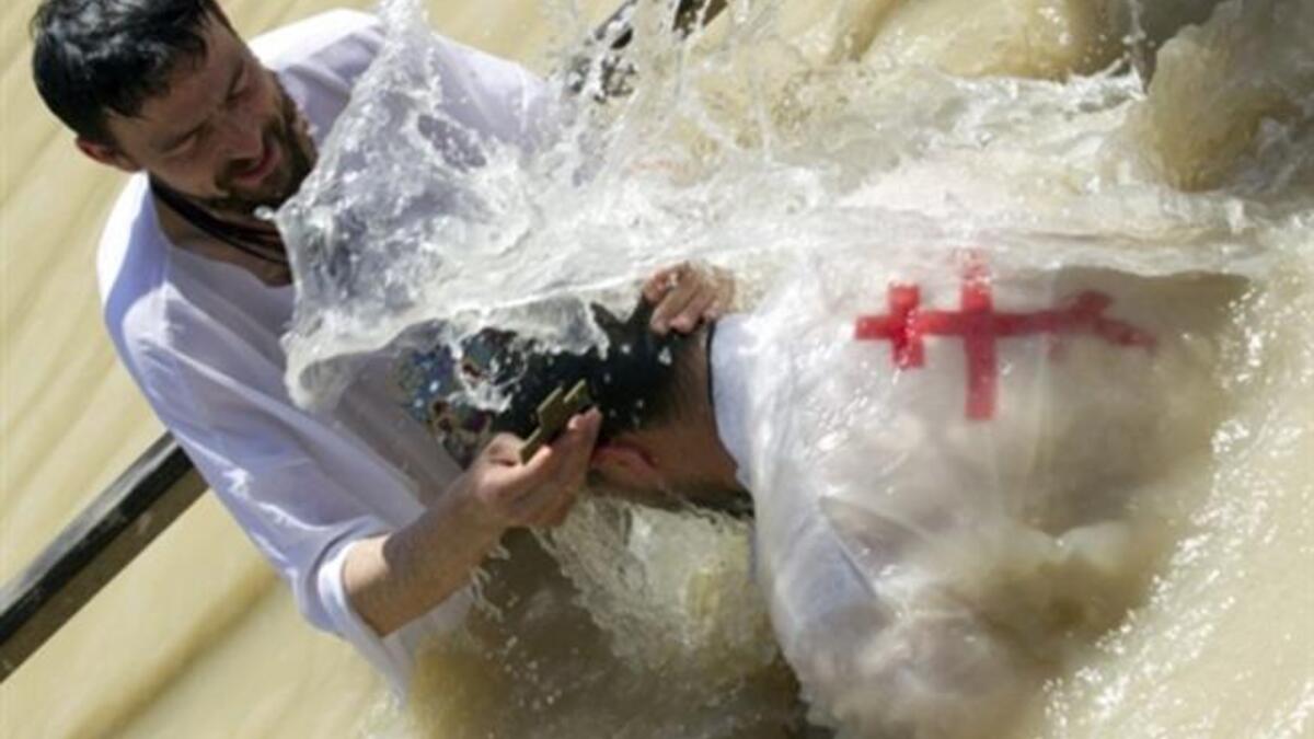 Palestine’s Palm Sunday: Christian Orthodox pilgrims attend a baptism ritual in the Jordan River near the West Bank city of Jericho, part of their Easter pilgrimage to the Holy Land.