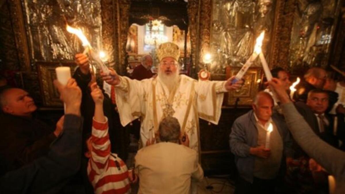 Bethlehem’s Bishop: The head of the Greek Orthodox church in Bethlehem holds the 'Holy Fire' brought from the Church of the Holy Sepulchre in Jerusalem during the 'Holy Fire' ceremony on the eve of the Orthodox Easter in Bethlehem.