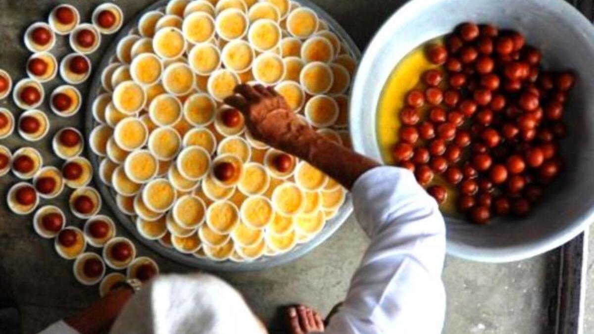 Nepal: Nepalese Muslim men prepare food to break the fast after the Jummat-Ul-Vida, the last Friday prayers, ahead of the Eid al-Fitr festival at the Kashmiri Mosque in Kathmandu. Sweets are often a center-piece in this three-day festival of a little decadence after a month of fasting.