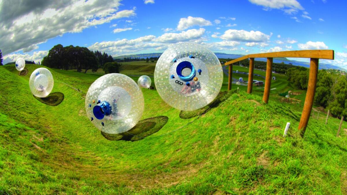 Roll Down A Hill In An Inflatable Ball In New Zealand: e are put inside enormous inflatable plastic balls and then pushed down hills. Apparently, it’s big in New Zealand, where riders volunteer to be pushed down hills in these plastic balls, which have no controls and offer no way to stop. (stayathomemum.com)