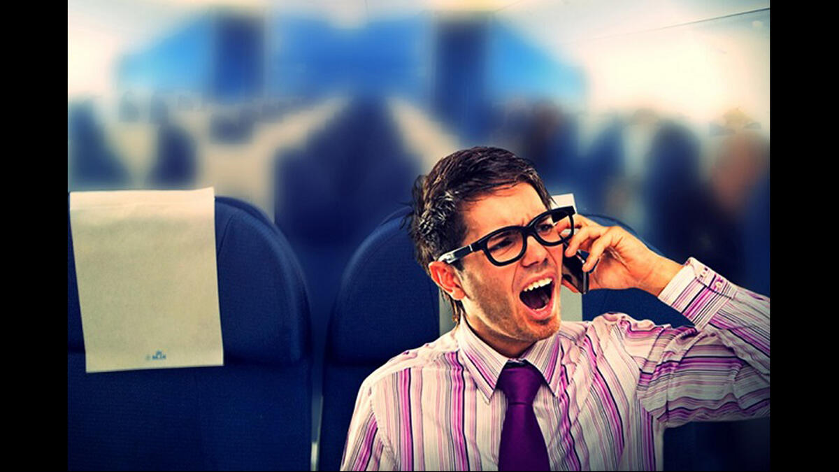 passenger on plane uses mobile