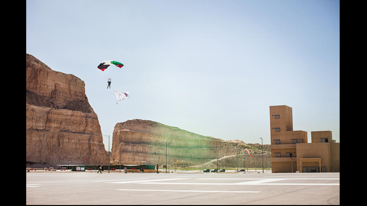 A parachuter from Jordan 71st counter-terrorism battalion prepares to land during the opening ceremonies of the seventh annual Warrior Competition at the King Abdullah II Special Operations Training Center near Amman, Jordan on April 19, 2015. This annual military competition brings together elite special operations teams from around the world.
