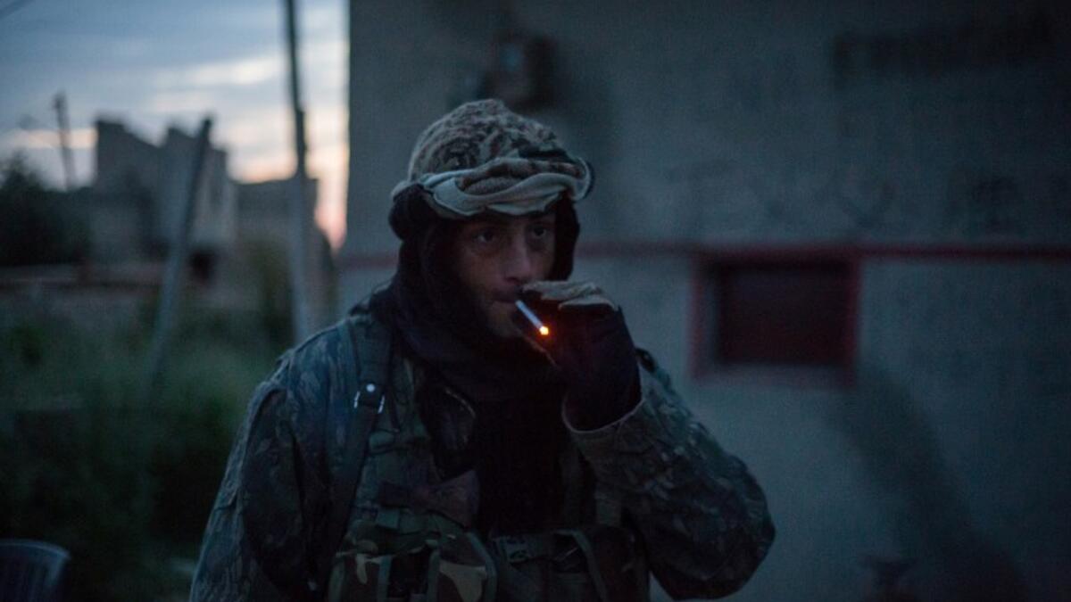 A 41-year from the US, nick-named ‘Hewal Azad,’ smokes a cigarette outside Tal Tamr on April 15, 2015.