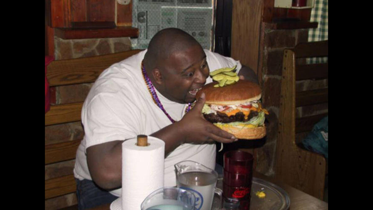 man eating huge burger