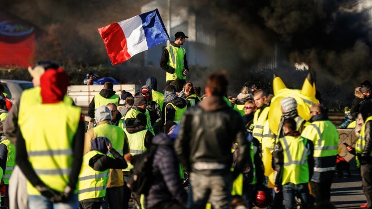 People block Caen's circular road on November 18, 2018 in Caen, Normandy, on a second day of action, a day after a nationwide popular initiated day of protest called "yellow vest" movement. 
CHARLY TRIBALLEAU / AFP