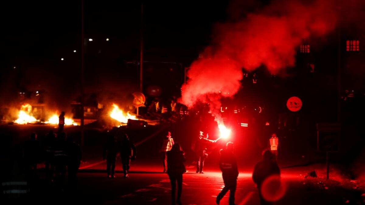 People block Caen's circular road on November 18, 2018 in Caen, northwestern France, on a second day of action after a nationwide popular initiated day of protest called "yellow vest" movement against high fuel prices.
CHARLY TRIBALLEAU / AFP