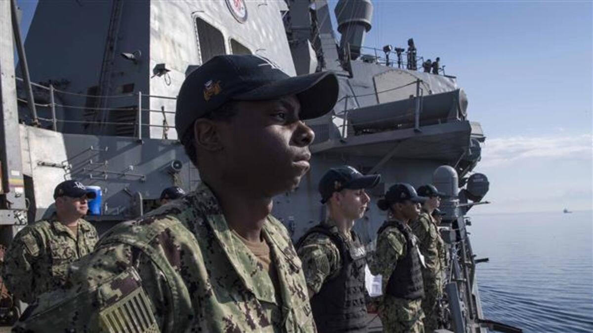 This US Navy photo obtained on Apr. 11, 2018 shows sailors as they man the rails aboard the Arleigh Burke-class guided-missile destroyer USS Donald Cook (DDG 75) as the ship departs Larnaca, Cyprus, on Apr. 9, 2018. (AFP)