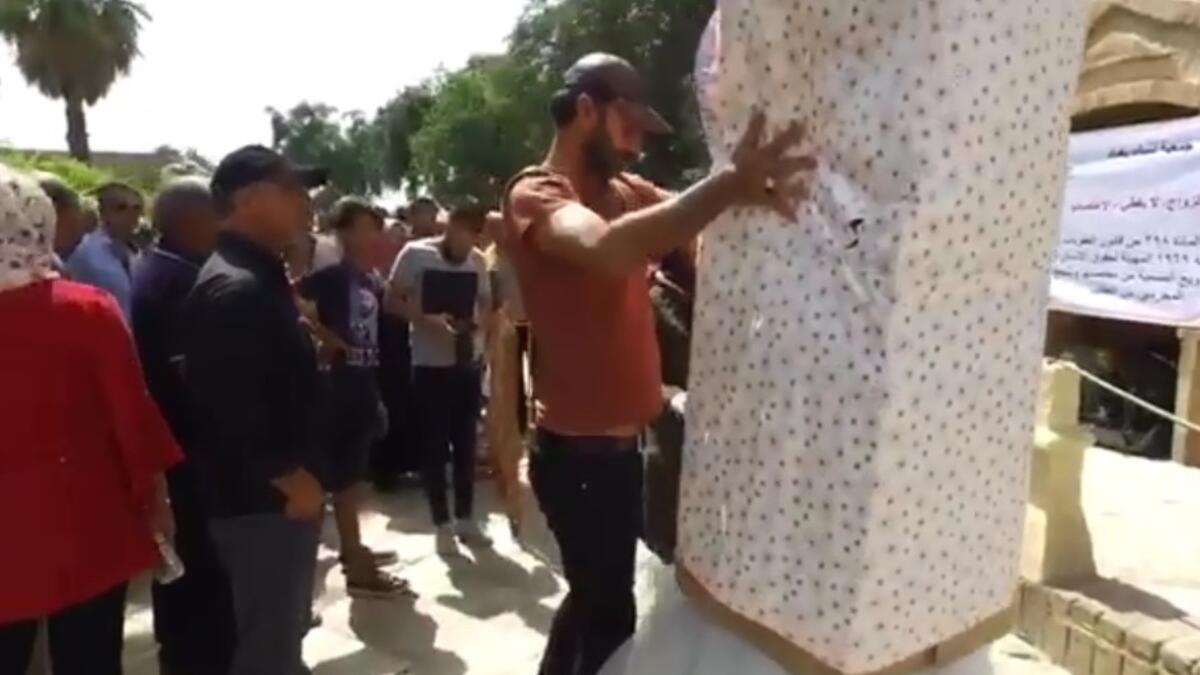 A huge gift-wrapped box with read “Gift of the Rapist”.
Baghdad's Woman Association