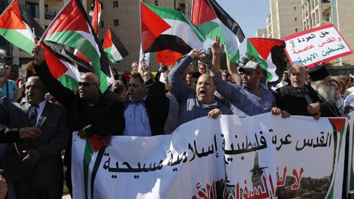 Arab demonstrators protest in front the new United States embassy in Jerusalem on May 14, 2018. The banner reads in Arabic " Jerusalem is Arab, Palestinian, Moslem, Christian". AHMAD GHARABLI / AFP