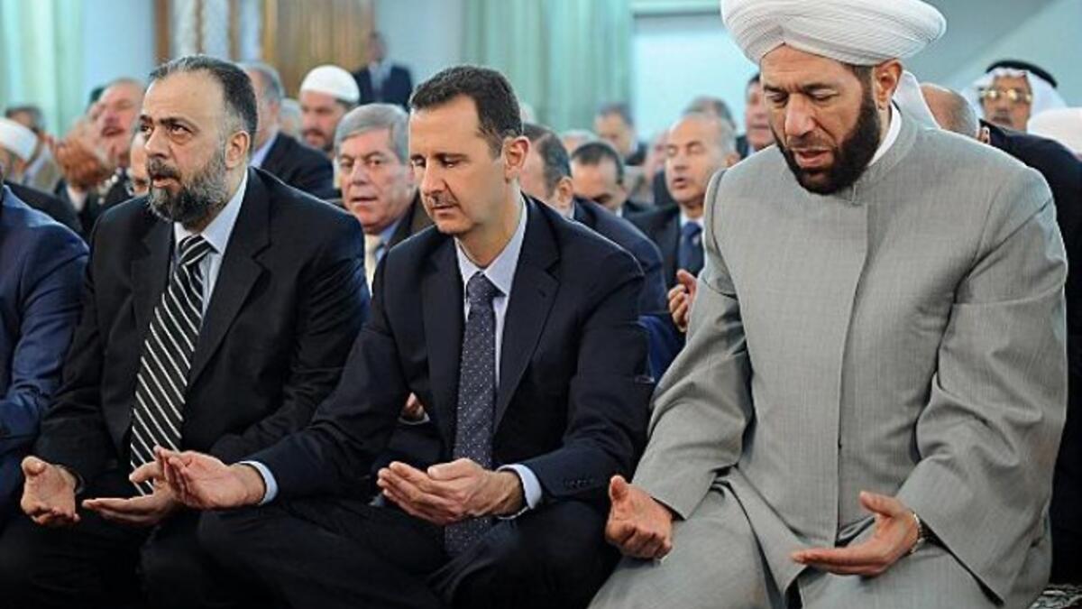 Alawites also different from other Muslims in their prayers, foregoing prostration but folding in songs. They practice “taqiyya”, pretending outwardly to be Sunni Muslim while hiding their real beliefs. Not every Alawi fasts, the hijab is not mandated, and some privately eat pork! (This image of Assad alleges he “prays like a Sunni”.)