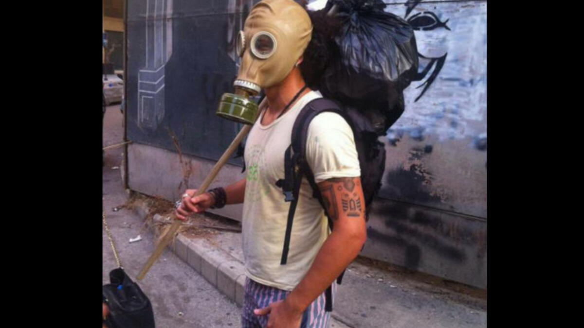 gas mask protester Lebanese trash