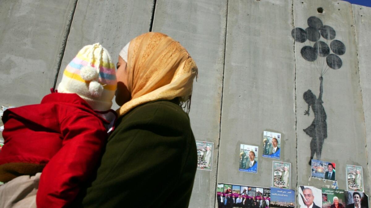 Flying Balloons Girl by Banksy, drawn on the security barrier in Bethlehem /AFP