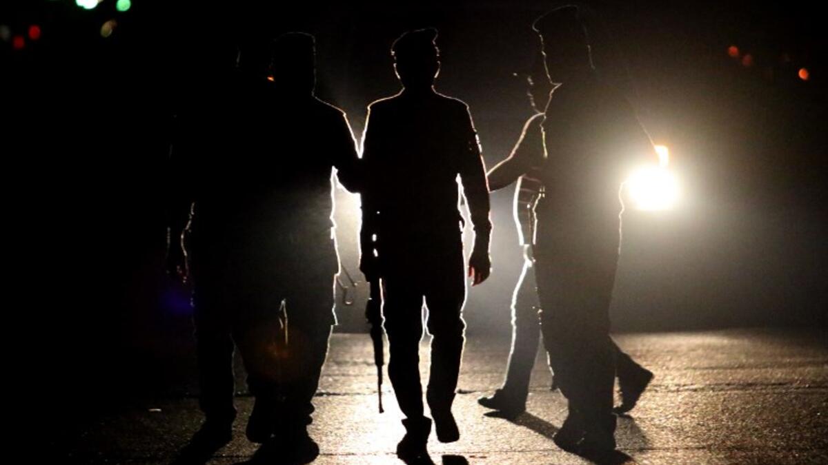 Iraqi security forces stand guard a street as protestors demonstrate against the government and the lack of basic services, on September 3, 2018 in the southern city of Basra. 
Haidar MOHAMMED ALI / AFP