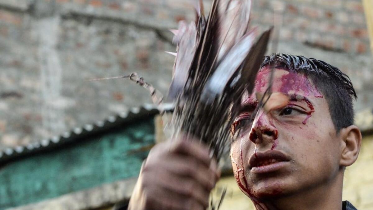 A Kashmiri Shiite Muslim mourner flagellates himself during a religious procession held on the seventh day of Ashura which remembers the slaying of the Prophet Muhammed's grandson in southern Iraq in the seventh century, in Srinagar on September 18, 2018. TAUSEEF MUSTAFA / AFP
