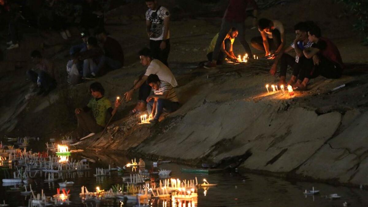 Pilgrims light candles outside of the Imam al-Mahdi shrine during the Shaabaniya ceremony commemorating the Imam's birth, the holiest figure for Shiite Muslims, in the central Iraqi city of Karbala, on May 2, 2018. the event comes two weeks before the start of the holy fasting month of Ramadan.
Mohammed SAWAF / AFP