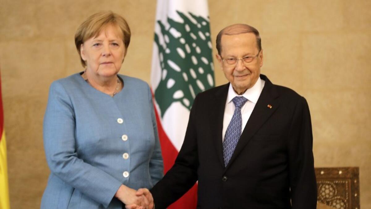 German Chancellor Angela Merkel (L) shakes hands with Lebanese President Michel Aoun at the presidential palace in Baabda, east Beirut, during her official visit on June 22, 2018. (AFP/Joseph Eid)