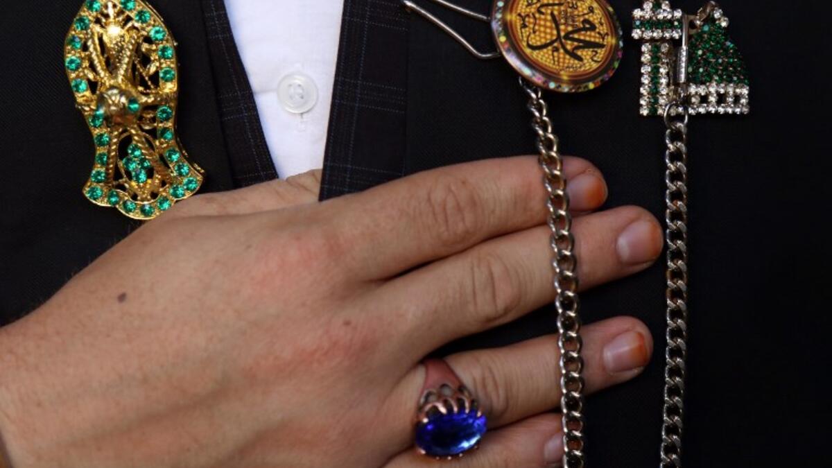 Religious symbols adorning the jacket of an Iraqi Sufi Muslim Kurd are pictured during a ritual ceremony to commemorate the birth of the Prophet Mohammed in the Kurdish town of Akra.
SAFIN HAMED / AFP