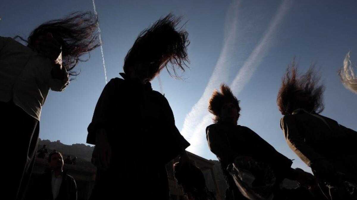 Iraqi Sufi Muslim Kurds take part in a ritual ceremony to commemorate the birth of the Prophet Mohammed.
SAFIN HAMED / AFP