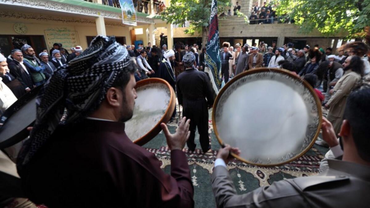 Iraqi Sufi Muslim Kurds take part in a ritual ceremony to commemorate the birth of the Prophet Mohammed in the Kurdish town of Akra. 
SAFIN HAMED / AFP