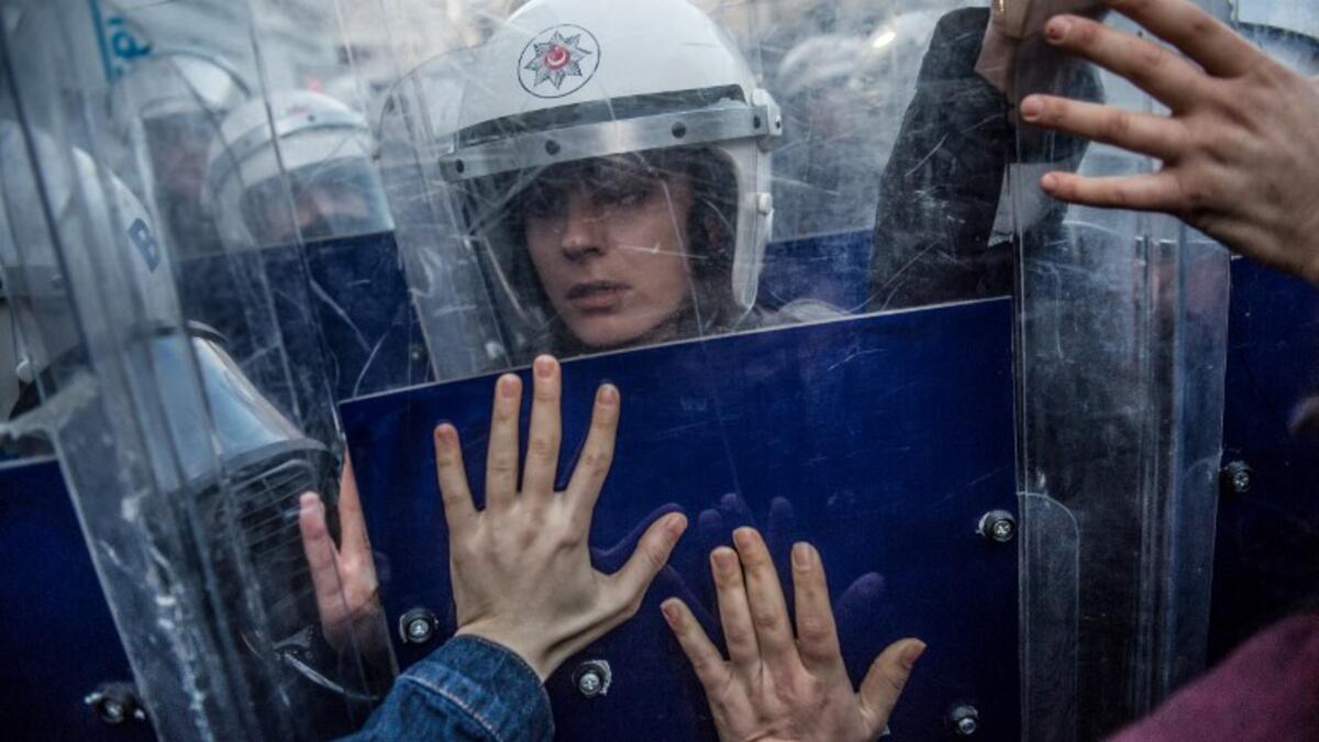 A Turkish female riot police officer reacts during clashes with women's rights activists as they try to march to Taksim Square to protest against gender violence in Istanbul, on November 25, 2018, on the International Day for the Elimination of Violence against Women. 
BULENT KILIC / AFP