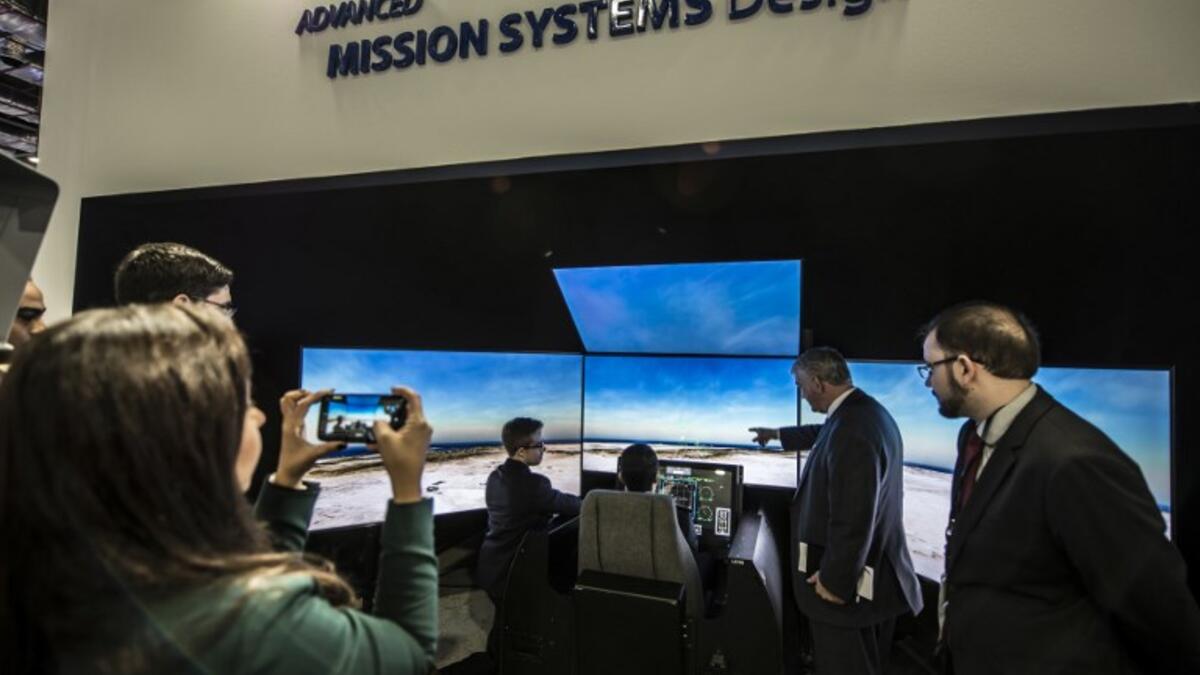 An Egyptian air force pilot (C) tests the simulator of the US-made F15 jet fighter at the Boing stand in Egypt’s first Service Defence Exhibition in Cairo on December 3, 2018, at the International Exhibition Center. 
Khaled DESOUKI / AFP