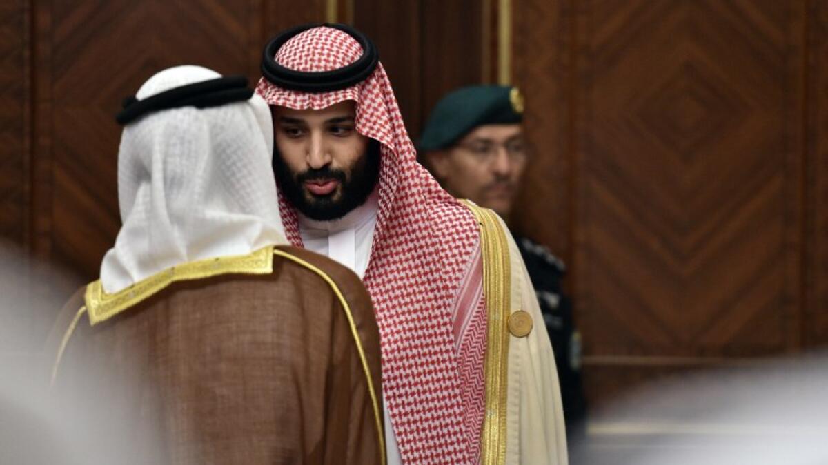 Saudi Crown Prince Mohammed bin Salman is pictured speaking to an unidentified man at the Diriya Palace in the Saudi capital Riyadh during the Gulf Cooperation Council (GCC) summit on December 9, 2018. Fayez Nureldine / AFP