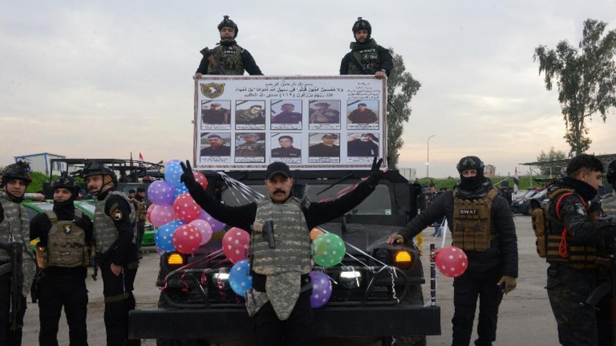 Members of the Iraqi security forces take part in celebrations marking the first anniversary of the country's victory over the Islamic State (IS) group, in the northern Iraqi city of Mosul, on December 10, 2018.
Zaid AL-OBEIDI / AFP