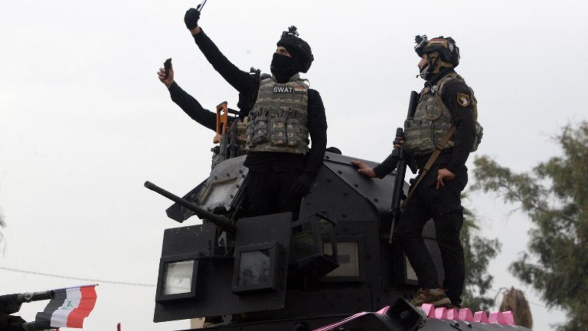 Members of the Iraqi security forces take part in celebrations marking the first anniversary of the country's victory over the Islamic State (IS) group.
Zaid AL-OBEIDI / AFP