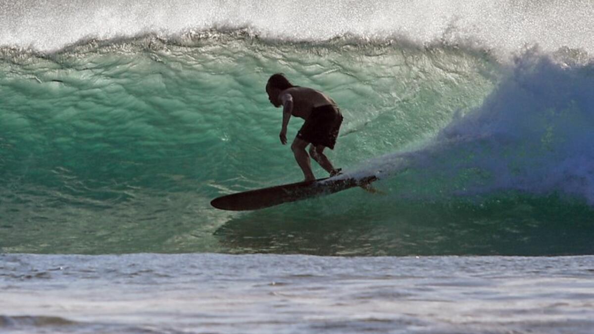 A surfer enjoys the waves at Las Baulas National Marine Park, Playa Grande, Costa Rica on December 10, 2018. David GANNON / AFP