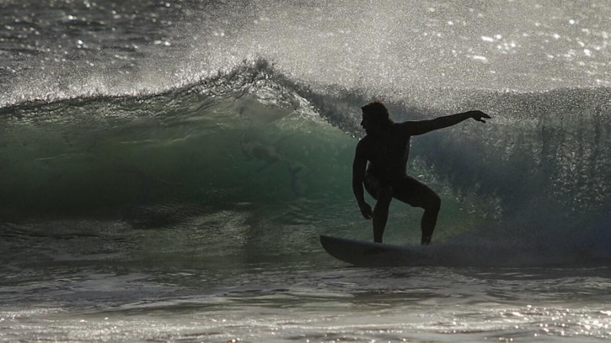 A surfer enjoys the waves at Las Baulas National Marine Park, Playa Grande, Costa Rica on December 10, 2018. David GANNON / AFP