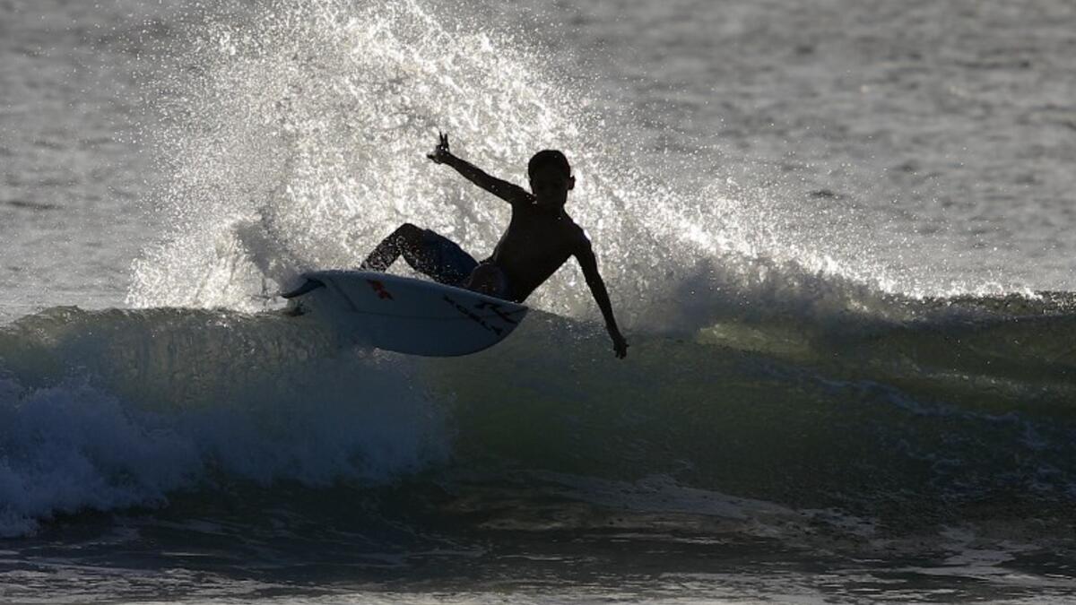 A surfer enjoys the waves at Las Baulas National Marine Park, Playa Grande, Costa Rica on December 10, 2018. David GANNON / AFP
