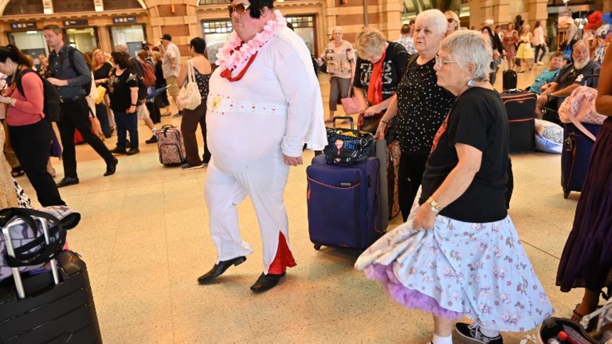Elvis fans dance to Elvis songs at Central station before boarding a train to to The Parkes Elvis Festival, in Sydney on January 10, 2019. 
PETER PARKS / AFP