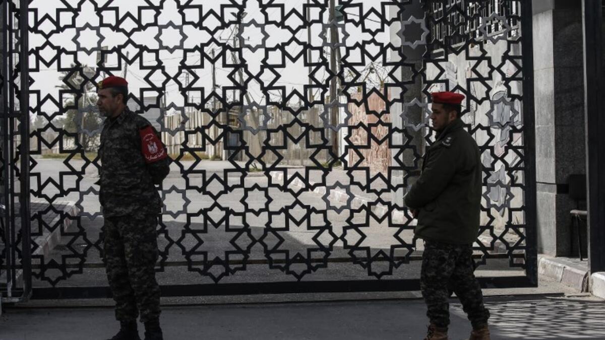 Palestinian security forces loyal to Hamas stand at the Rafah crossing point between Egypt and the southern Gaza Strip on January 24, 2019 in Rafah. 
SAID KHATIB / AFP
