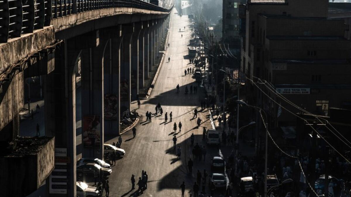 People walk on a street in Addis Ababa on February 3, 2019 during the third Car Free Day promoted by local NGOs and the Ethiopian Government to appeal a healthy life style and a less air pollution of the capital city. 
EDUARDO SOTERAS / AFP
