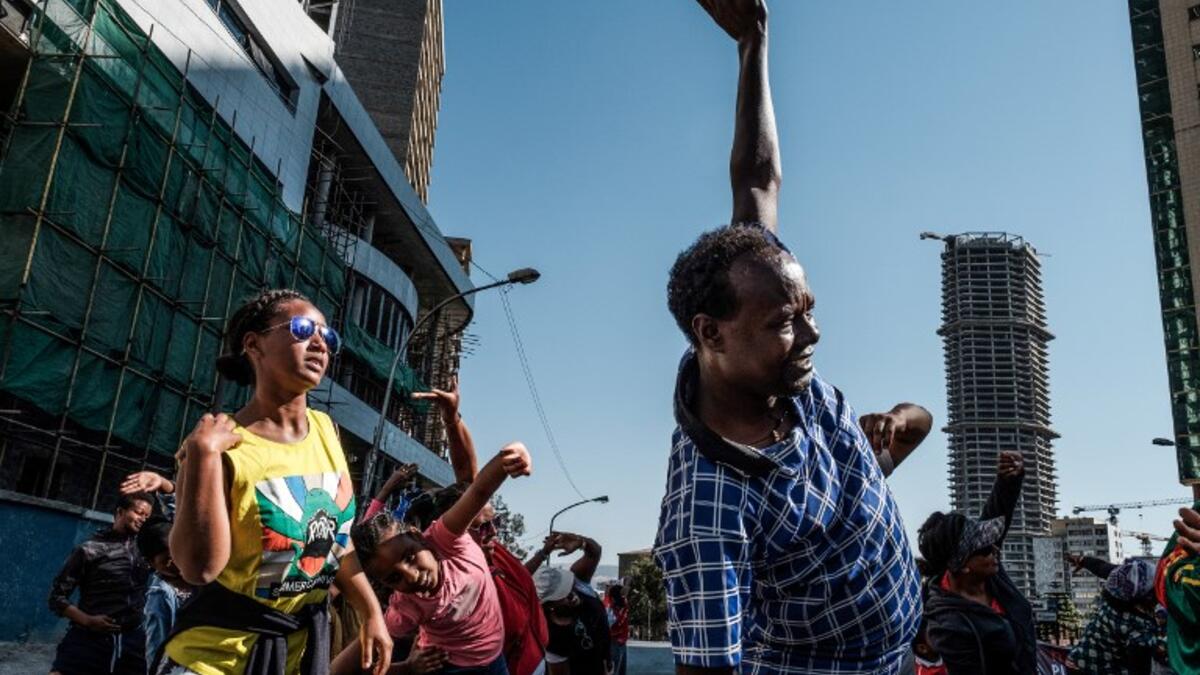 People take part in an exercise on a street in Addis Ababa on February 3, 2019 during the third Car Free Day promoted by local NGOs and the Ethiopian Government to appeal to a healthy life style and a less air pollution of the capital city. 
EDUARDO SOTERAS / AFP