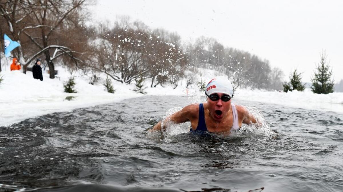 Natalya Seraya, the founder and chief of Moscow's ice swimming club "Walruses of the Capital", swims in a strip of water cut in the ice by the bank of the Moscow River on February 3, 2019. 
Kirill KUDRYAVTSEV / AFP