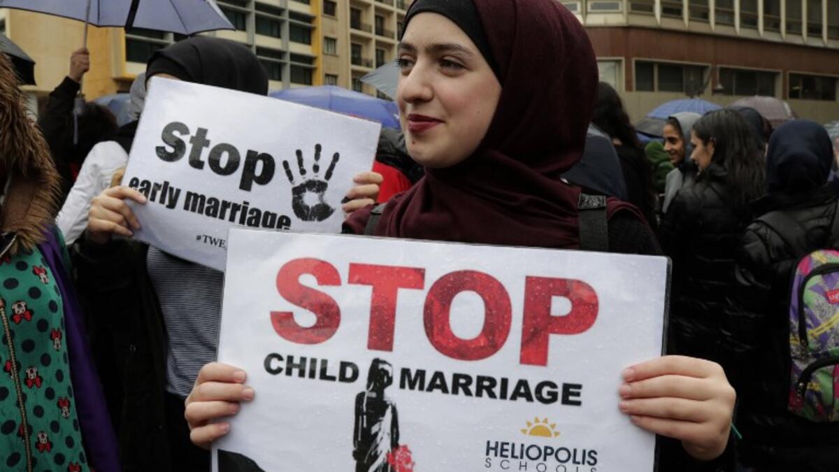 A Lebanese woman hold a placard as she participates in a march against marriage before the age of 18, in the capital Beirut on March 2, 2019. 
ANWAR AMRO / AFP