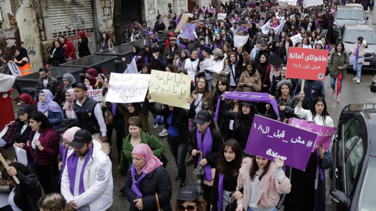 Lebanese demonstrators hold placards as they participate in a march against marriage before the age of 18 in the capital Beirut, on March 2, 2019. 
ANWAR AMRO / AFP