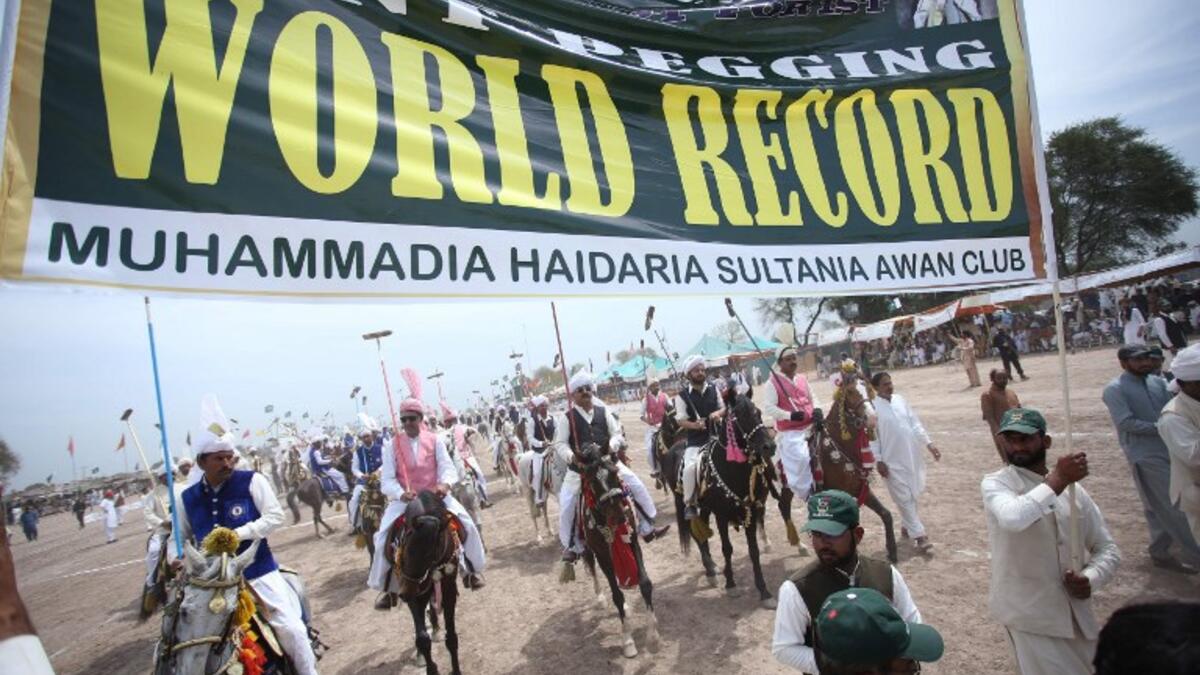 Pakistani horse riders during an attempt for a Guinness World Record for tent pegging in Khanewal district in Punjab province.
SS MIRZA / AFP